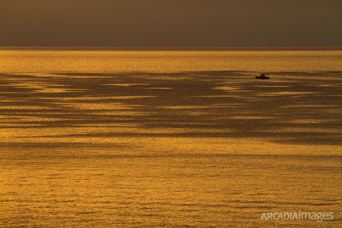 Sunrise light on the Messenian gulf as seen from Peroulia village. Messenia, Peloponnese, Greece